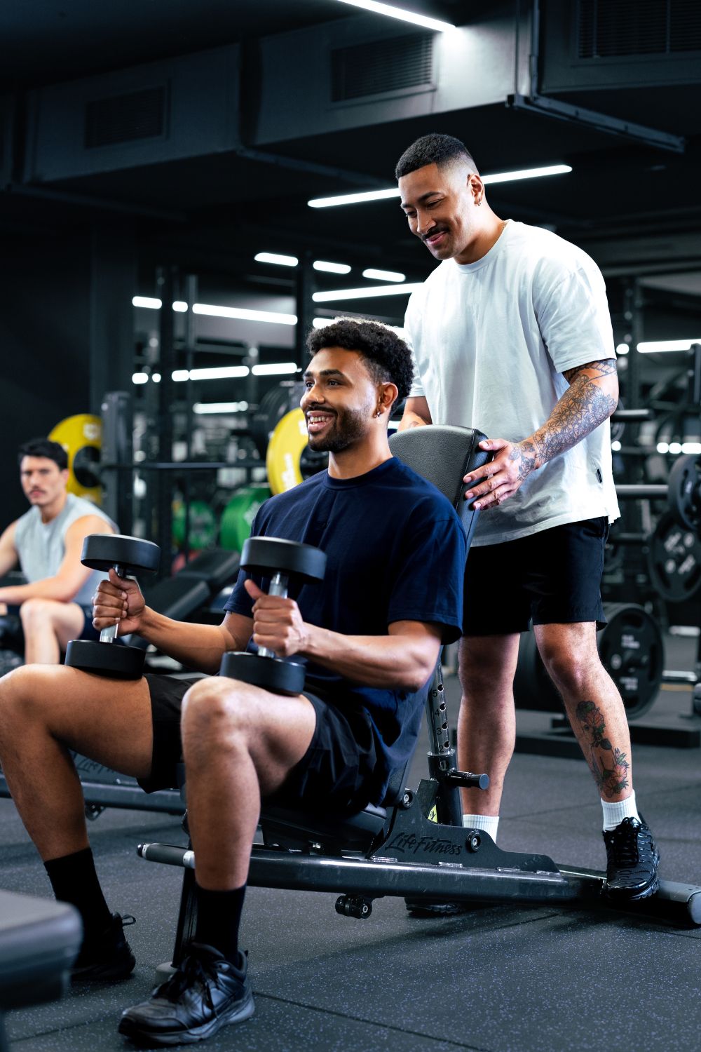 Weight training session with personal trainer support at gym in Pune